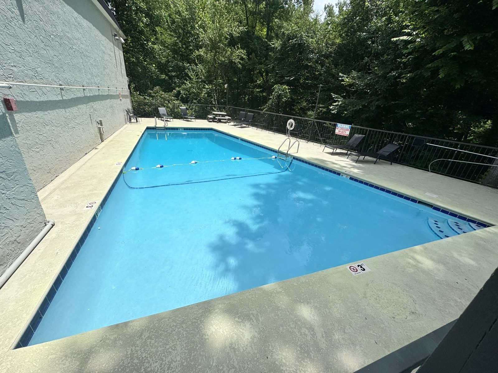 Motel 6 Gatlinburg outdoor pool surrounded by Smoky Mountain greenery